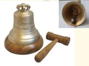cPaccard bronze bell with its bronze handle placed on a wooden base